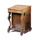 A VICTORIAN ROSEWOOD DAVENPORT, C1860 fitted with drawers and opposing blind drawers, 85cm h; 56 x