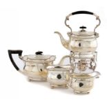 A GEORGE V SILVER FOUR PIECE TEA SERVICE, the teapot with integral hinge, kettle and lampstand