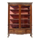 A PARCEL GILT MAHOGANY SERPENTINE CABINET BY WARINGS, C1920 the glazed doors and drawer surrounds in