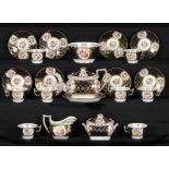 A COALPORT TEA SERVICE, C1820 with painted floral panels on a cobalt ground, a silver shaped teapot,