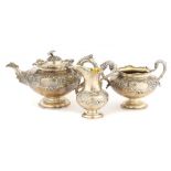 A SCOTTISH VICTORIAN SILVER TEA SERVICE crisply chased with flowers and foliage, teapot 17cm h, by