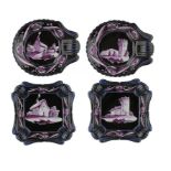 TWO PAIRS OF STAFFORDSHIRE WHITE AND PURPLE ENAMEL PAINTED BLACK GROUND EARTHENWARE DESSERT