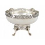 AN IRISH GEORGE V SILVER FRUIT BOWL AND STAND with cast openwork borders of celtic revival ornament,
