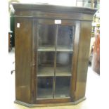 A MAHOGANY STAINED CORNER CABINET