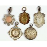 FIVE SILVER WATCH FOB SHIELDS, TWO CAST IN SHALLOW RELIEF WITH FOOTBALLERS, VARIOUS MAKERS AND