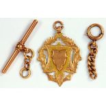 A 9CT GOLD WATCH FOB SHIELD, A GOLD T BAR AND A SMALL PIECE OF GOLD CHAIN, 9.4G