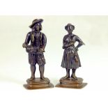 A PAIR OF CONTINENTAL MINIATURE BRONZE STATUETTES OF A MAN PLAYING THE HURDY GURDY AND A YOUNG WOMAN