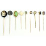 NINE VICTORIAN GOLD OR BASE METAL STICKPINS WITH AGATE, PASTE OR OTHER TERMINAL