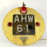 VINTAGE MOTORING.  A PAINTED METAL MOUNTED NUMBER PLATE 'A.H.W. 61' AND TRIANGULAR BADGE OF THE