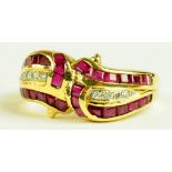 A RUBY AND DIAMOND CROSSOVER RING, WITH LINES OF DIAMONDS FLANKED BY CALIBRE CUT RUBIES IN GOLD,