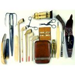 A SILVER MOUNTED TAN LEATHER CIGAR CASE, GILTMETAL MANICURE SET ON LEATHER STAND, FIVE CLAY PIPES, A