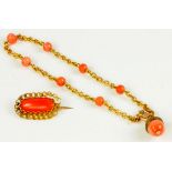 A VICTORIAN GOLD AND CORAL BRACELET WITH ACORN PENDANT AND A SIMILAR BROOCH
