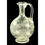 A VICTORIAN GLASS CARAFE, FINELY ENGRAVED TO EITHER SIDE WITH TRAILING IVY