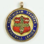 SOCCER.  A 9CT GOLD AND ENAMEL MEDAL OF NOTTINGHAM SPARTAN FOOTBALL LEAGUE, REVERSE ENGRAVED
