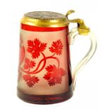 A 19TH CENTURY COPPER GILT MOUNTED BOHEMIAN, RUBY FLASHED AND ETCHED GLASS TANKARD, WITH STAR CUT