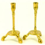 A PAIR OF CONTINENTAL BRASS THREE FOOTED CANDLESTICKS, POSSIBLY SPANISH, 18TH/19TH CENTURY