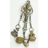 A VICTORIAN BRIGHT STEEL CHATELAINE CLIP WITH FOUR ACCESSORIES, INCLUDING AN EARLIER 18TH CENTURY