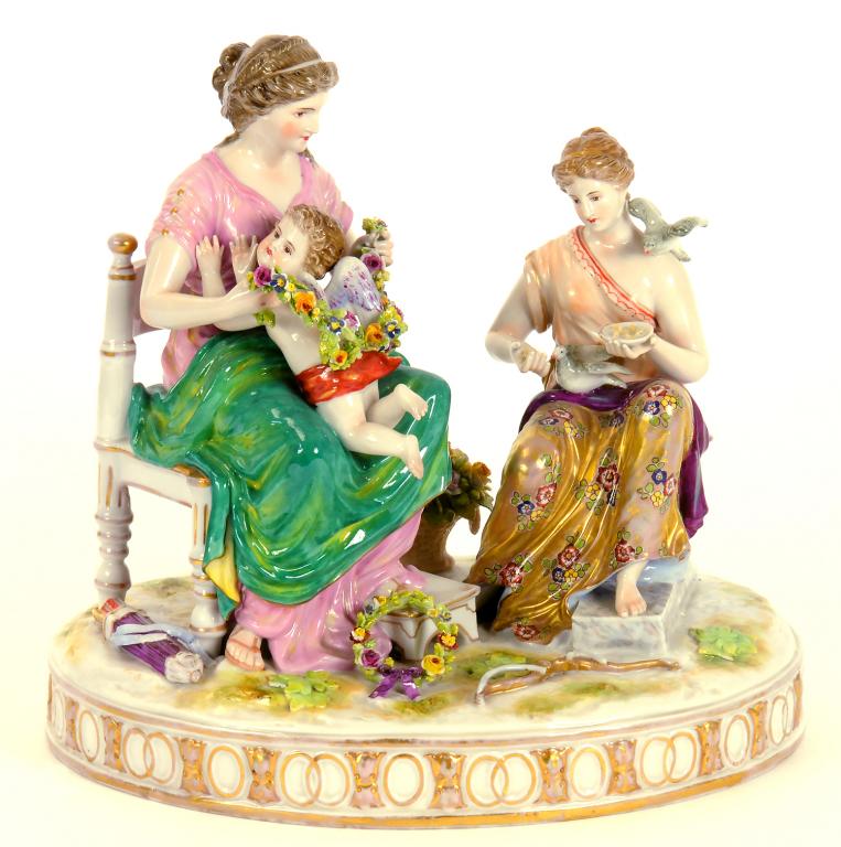 A GERMAN PORCELAIN GROUP OF TWO YOUNG CLASSICAL WOMEN WITH PUTTO, ON OVAL BASE, 20TH CENTURY