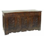 A CARVED OAK CHEST