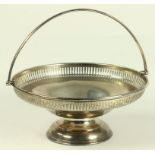 A GEORGE V SILVER CAKE BASKET WITH PIERCED BORDER AND SWING HANDLE, BIRMINGHAM 1921, 15OZS