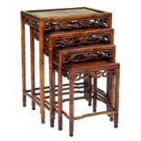 A NEST OF FOUR CHINESE CARVED WOOD TABLES, EARLY 20TH C