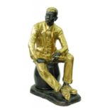 *A HALF LIFE SIZED BRASS FIGURE OF A BLACK MAN SEATED ON A BARREL