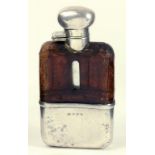 A GEORGE V SILVER MOUNTED GLASS HIP FLASK WITH CROCODILE HIDE COVERED SHOULDER, BIRMINGHAM 1931