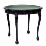 A CARVED AND BLACK PAINTED WOOD OVAL TABLE