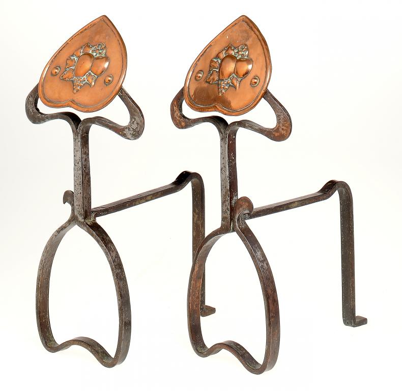 A PAIR OF ENGLISH ART NOUVEAU WROUGHT IRON AND EMBOSSED COPPER  ANDIRONS, C1905  38cm h ++In very