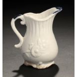 AN INTERESTING UNASCRIBED ENGLISH PORCELAIN BLUE AND WHITE CREAM JUG, C1770-80  moulded to either