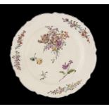 A FINE CHELSEA MOULDED DISH, C1758  painted with sprays and scattered flowers, in brown rim, 32cm