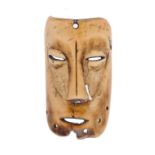 TRIBAL ART. A WEST AFRICAN CARVED BONE MASK 9.5cm h ++Much wear and handling marks, split with small