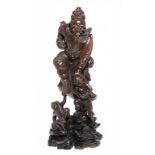 A JAPANESE CARVED WOOD FIGURE OF SHOKI THE DEMON QUELLER, LATE 19TH C 78cm h, inset with bone