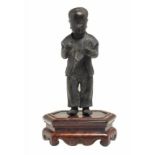 A CHINESE BRONZE FIGURE OF A BOY, 19TH C  black patina, 21cm h, on a hardwood base (2) ++Figure with