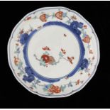A JAPANESE KAKIEMON PLATE, 18TH C enamelled with kiku, other flowers and peaches, 20.5cm diam,