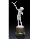 FERDINAND PREISS.  AN IVORY FIGURE OF A YOUNG GIRL WITH A BIRD, C1930  on oval onyx base, 17.5cm