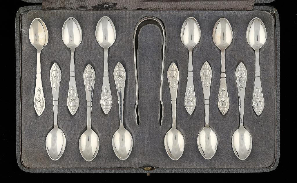 A SET OF TWELVE GEORG JENSEN SILVER FUSCHIA PATTERN COFFEE SPOONS AND A PAIR OF SUGAR BOWS, DESIGNED