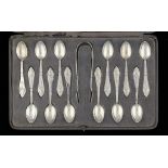 A SET OF TWELVE GEORG JENSEN SILVER FUSCHIA PATTERN COFFEE SPOONS AND A PAIR OF SUGAR BOWS, DESIGNED