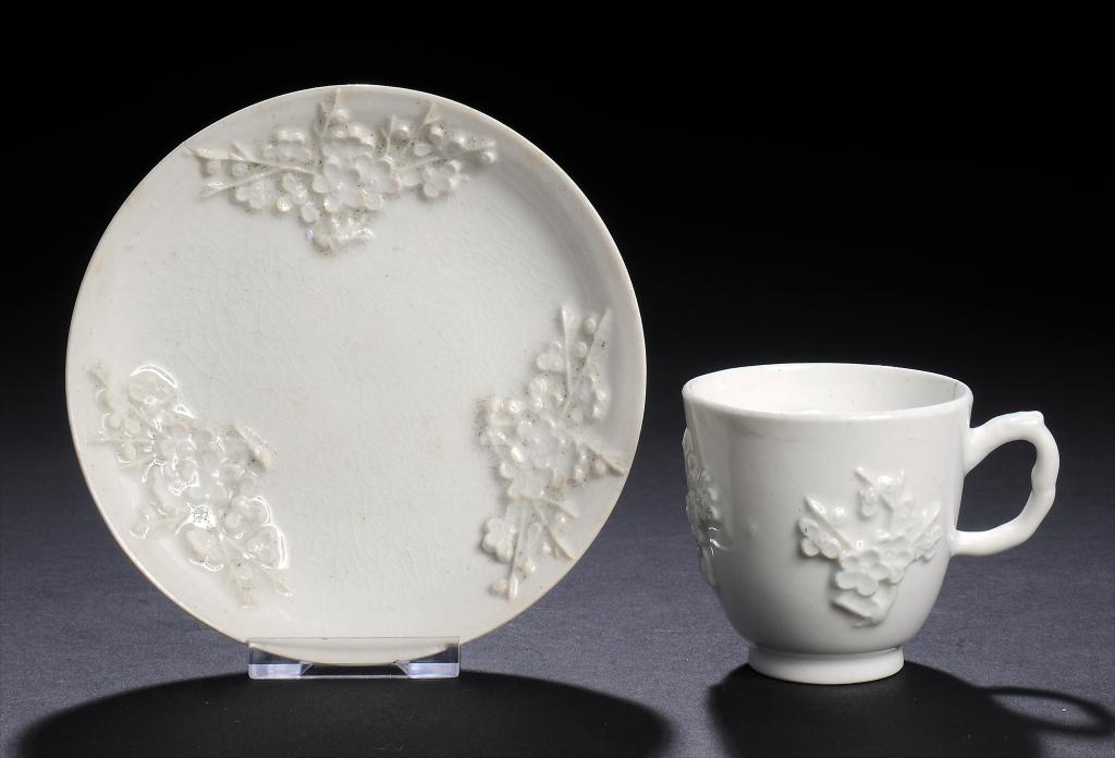 A BOW PRUNUS MOULDED COFFEE CUP AND SAUCER, C1754-6 saucer 11.5cm diam ++Cup with stained descending