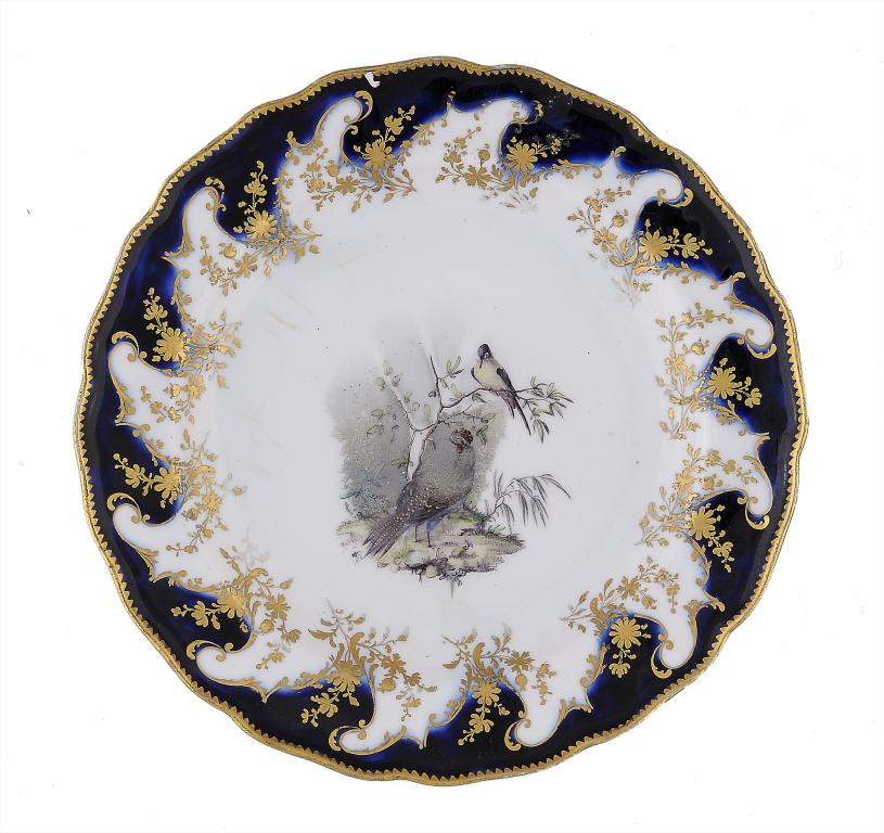 A CHELSEA MAZARINE GROUND PLATE, C1765 enamelled with birds in branches, 21cm diam, gilt anchor ++