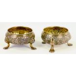 A PAIR OF GEORGE III SILVER SALT CELLARS ON THREE FEET, LATER CHASED, LONDON MARKS RUBBED, 5OZS