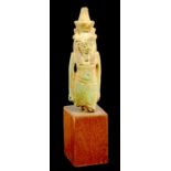 AN EGYPTIAN FAIENCE AMULET IN THE FORM OF A WALKING FIGURE OF A DEITY, POSSIBLY AMUN, LATE PERIOD,