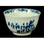 A WORCESTER REEDED TEA BOWL, C1755-60 painted  in underglaze blue with the Feather Mould Floral