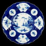 A WORCESTER POWDER BLUE GROUND PLATE, C1758-62 painted with round and fan shaped panels of Chinese