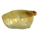 A CHINESE JADE BRUSH WASHER IN THE FORM OF A LEAF, 19TH C  the russet coloured stalk forming the