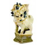 A CHINESE CREAM AND BROWN GLAZED TILEWORKS JOSS STICK STAND MODELLED AS A DOG OF FO, 17TH C  16cm