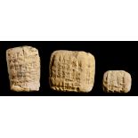 THREE SUMERIAN CLAY CUNEIFORM TABLETS, C2000 BC  the largest c 5cm w, (ex Garry Edwards, Newark)