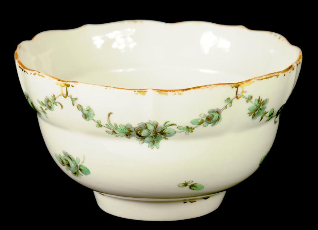 A BRISTOL OGEE SLOP BASIN, C1775-78 painted in green monochrome with swags, 14.5cm diam, blue enamel