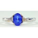A TANZANITE AND DIAMOND RING WITH TRIANGULAR DIAMONDS TO THE SHOULDERS IN 18CT WHITE GOLD, 3.1G