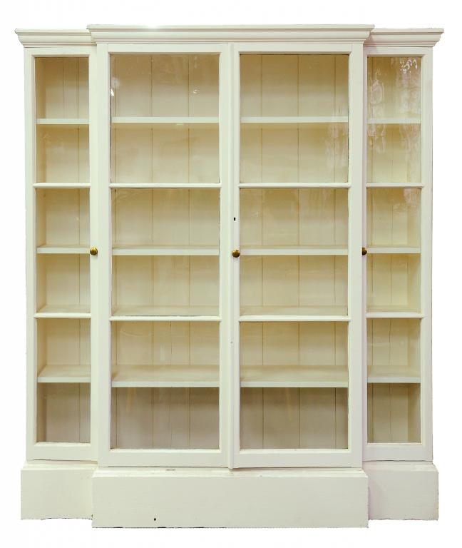 A GEORGE III STYLE WHITE PAINTED BREAKFRONT BOOKCASE ENCLOSED BY FOUR GLAZED DOORS